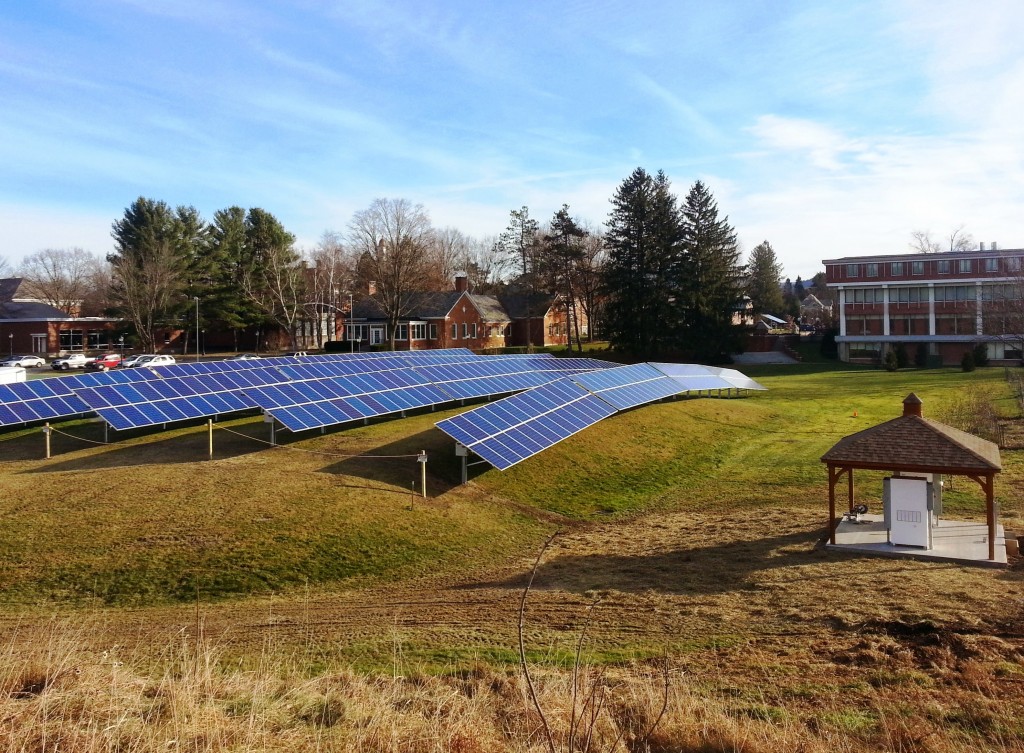 A ground mounted solar array at a school, with a shed for the inverter. 