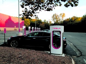 Three Teslas are charging at a shopping center in the small town West Lebanon, New Hampshire. With five more stations that could be used, this site can handle a lot of traffic. And more are coming. Photo by GET's editor, Nancy Rae Mallery.