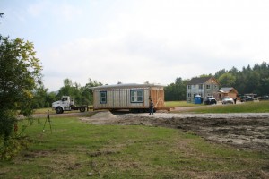 A module for the second high efficiency home being delivered. The first high efficiency modular home is in the background. Photo courtesy of Kika McArthur.