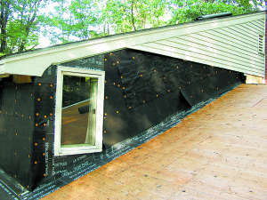 Wall flashing using underlayment. Metal step flashing will be added as part of the shingling. Additional building paper will lap over the step flashing and under the upper course of building paper. All Photos courtesy of Michael Goetinck