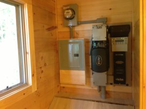 An off-grid solar system at Lake Champlain includes an Outback VFX3524 inverter, Outback FM80 charge controller, DPW top of pole rack and eight Rolls S460AGM batteries. The installer was Integrity Energy of E. Bethel, VT.