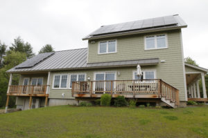 A BrightBuilt Home in Meriden, NH. This zero energy home was built by RH Irving. This south-facing side features Logic windows and doors and a solar array installed by Norwich Solar Technologies;