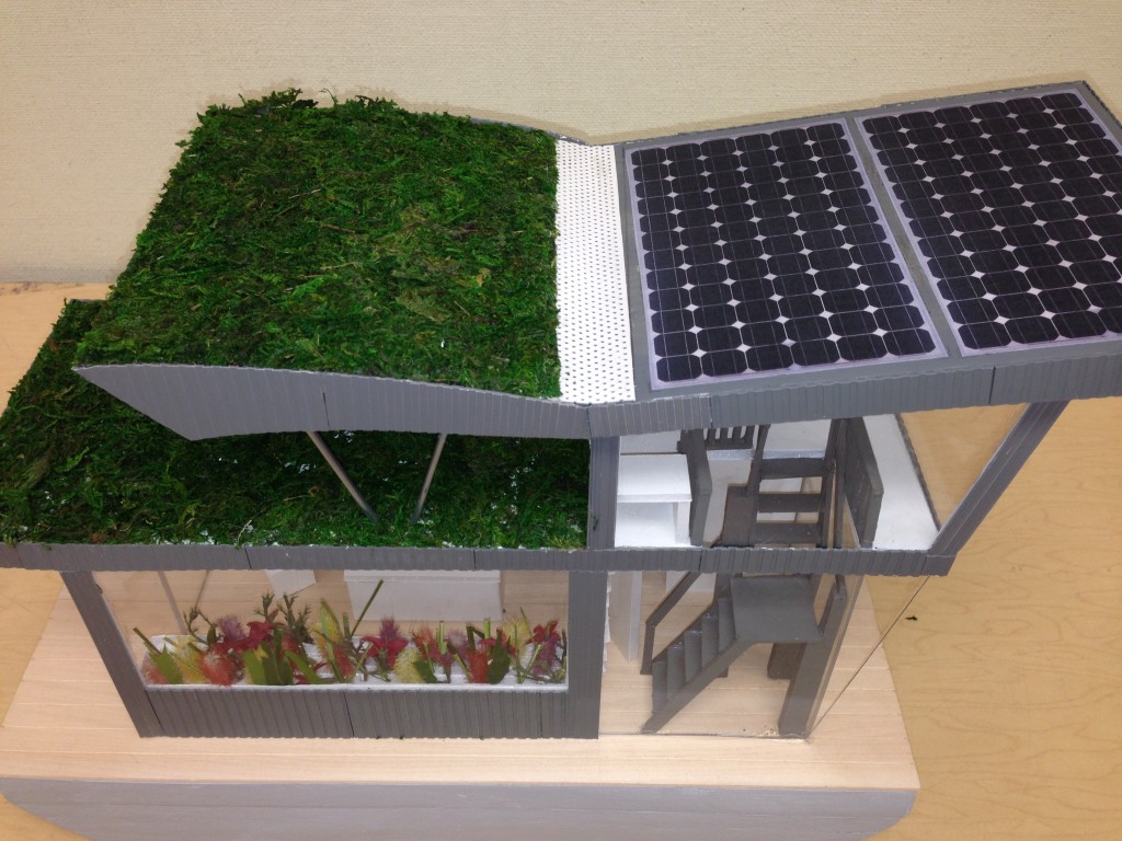 This model of a house boat embodies a variety of green building principles, one of which is energy efficiency.  Passive solar design and low-e glazing help improve thermal efficiency, while photovoltaics produce renewable energy, and Energy Star equipment increases electrical efficiency. Beyond efficiency, the boat also has a green roof for food production and a cistern to capture rainwater.  Constructed wetlands on-board use local species to treat wastewater generated by the boat, and also serve an ecological restoration function.  Nutrient-rich lake water containing unwanted algae blooms is pumped through the wetlands, which digest excess nutrients to improve lake water quality.  In the words of UVM students Brynna Barbour and Vanessia Lam who designed and built the model, “it’s a sustainable house boat design that is completely off the grid and is able to self-regulate while purifying the water that it calls home.”