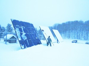 Cleaning off snow from ground-mounted solar panels (PV) with the SnoPro Brum. 