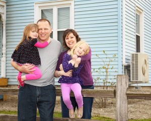 This Baxter Street home is the first in the GMP eHome pilot program. Pictured are Sara and Mark Borkowski with their daughters. 